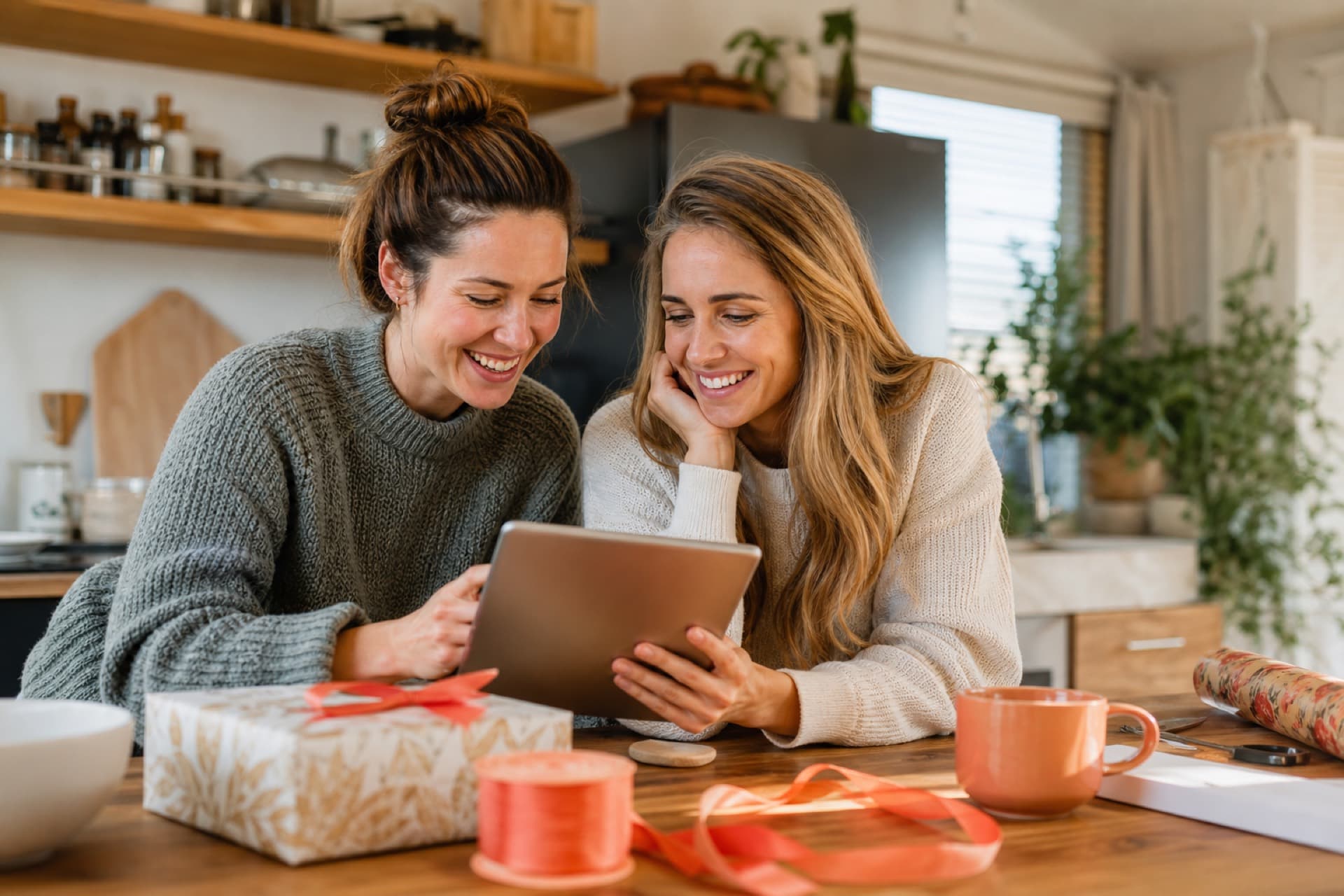 Friends planning gifts together at a kitchen island